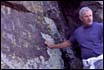 Thumbnail of Roger Tomalty with petroglyph